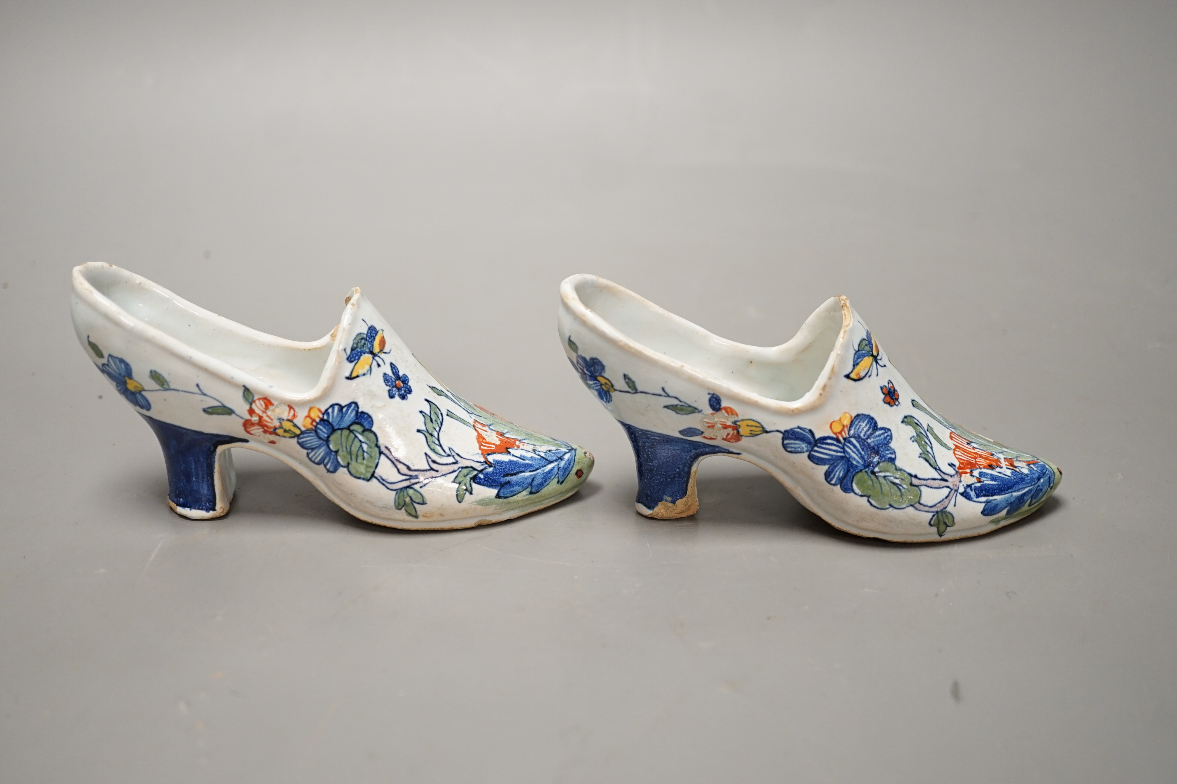 A pair of 19th century Delft polychrome models of shoes, 14cms wide